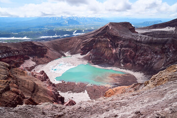 Emerald lake in the crater of the volcano. Summer landscape, Kamchatka peninsula, Russia