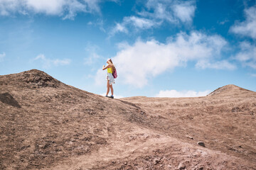 Young woman hiking to the top of the volcano. Kamchatka peninsula