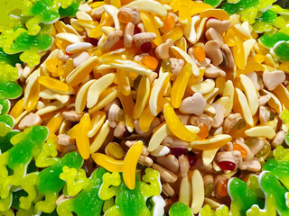 Colorful jelly bananas and frogs candies. Full frame texture background. Closeup, a lot, heap