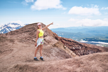 Young woman hiking to the top of the volcano. Kamchatka peninsula