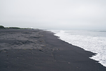 Deserted beach with black sand. East coast of Kamchatka peninsula