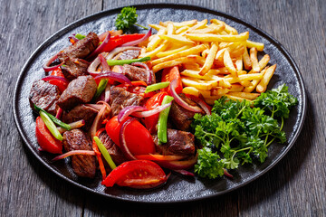 Lomo saltado, fried beef, french fries, veggies