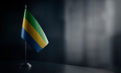 Small national flag of the Gabon on a black background
