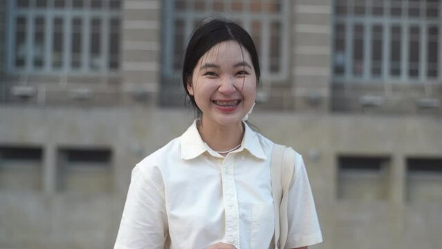 Happy young asian millennial woman smiling with braces in casual outfit, positive and confident female teenager
