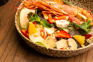 Shrimp salad with berries and cheese