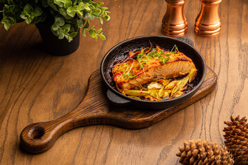 Baked salmon with chips and vegetables