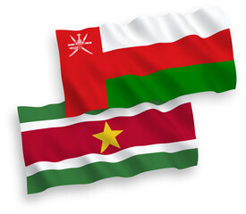 Obraz premium Flags of Sultanate of Oman and Republic of Suriname on a white background