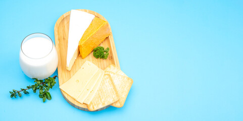 Blue background for holidays Shavuot, Pentecost. Milk, traditional bread and homemade cheese...