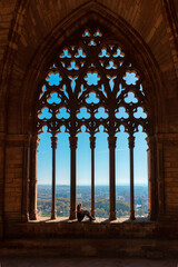 Woman tourist looking at panoramic view of Lleida city landscape from cathedral