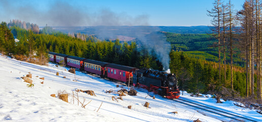 Steam train during winter in the snow in the Harz national park Germany,train Brocken Bahn on the way through the winter landscape, Brocken, Harz Germany