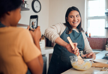 Baking, tutorial and social media with a chef woman in the kitchen of her home cooking as an influencer. Food, phone and vlog with a female cook preparing baked goods while live streaming in a house - obrazy, fototapety, plakaty