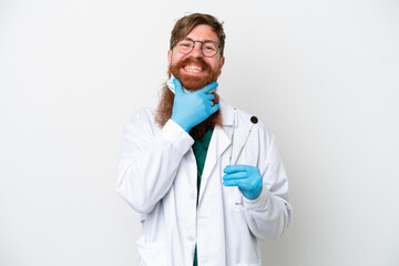 Dentist reddish man holding tools isolated on white background happy and smiling