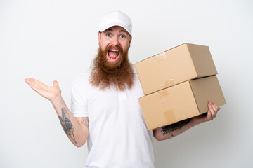 Delivery reddish man isolated on white background with shocked facial expression