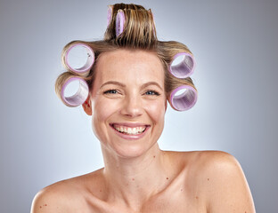 Face, hair care and woman with hair roller in studio isolated on gray background. Beauty portrait, makeup and cosmetics of happy female model with salon hair treatment or curler product for hairstyle