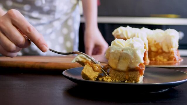 Banoffi cake made of shortbread, bananas and homemade caramel, cake with bananas, caramel and cream , cut a piece