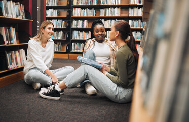 Library, book and group of women reading for education, research and knowledge at university. Discussion, scholarship and female students studying for a test, exam or assignment together at college.