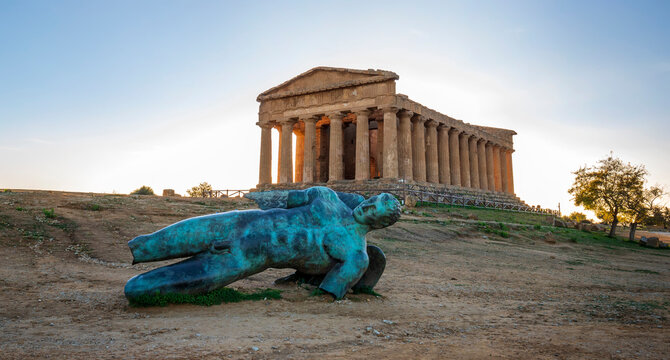 Temple of Concordia and the statue of Fallen Icarus, in the Valley of the Temples, Agrigento, Sicily, Italy