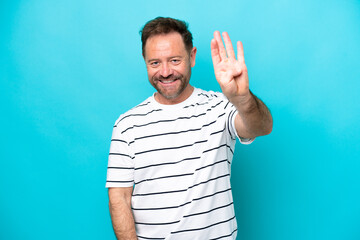Middle age caucasian man isolated on blue background happy and counting four with fingers