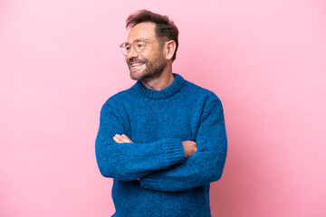 Middle age caucasian man isolated on pink background happy and smiling