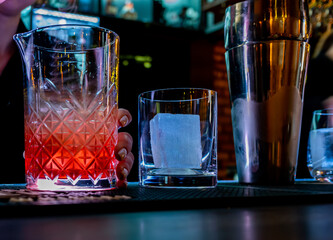 woman bartender making cocktail in bar