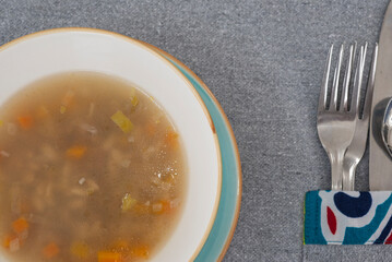 Vegetable soup a la carte meal in a bowl with cutlery