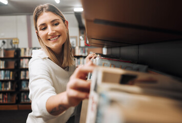 Library books, student and woman packing textbook in a education, university and learning book shop. School, college and happy graduate looking for knowledge, studying and learning with a smile