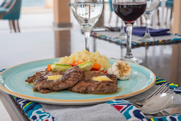 Beef steak a la carte meal with pepper sauce on blue plate