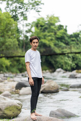 An Asian Man With White Shirt Posing Near a River in the Nature