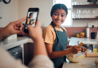 Baking, girl and phone picture of a child cooking in home kitchen with a proud smile about...