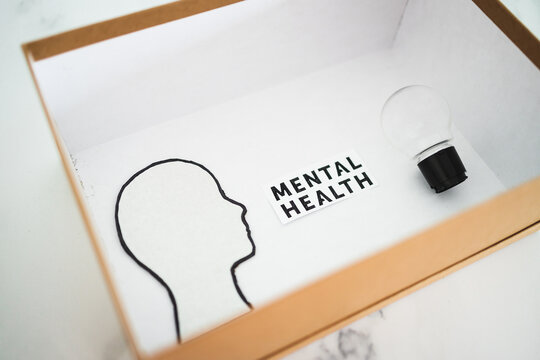 mental health text in box next to cardboard head with light bulb