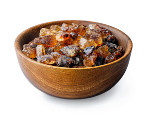 brown caramelized sugar in wooden bowl isolated on white