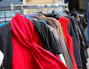 red shirt with scarf and other clothes for sale in used and new clothes stall