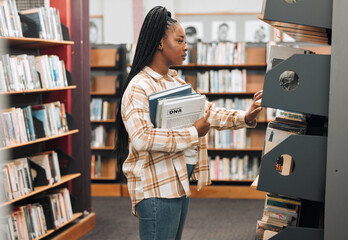 Books, education or black woman in a library to search for knowledge by bookshelf on a school or...