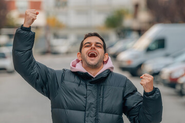 euphoric man celebrating success in the street outdoors