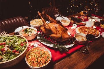 Baked chicken or turkey on served for Christmas table for Christmas Dinner and New Year with Christmas decorations.