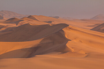 Desert off the coast of the Atlantic Ocean. Beautiful sunset. Walvis Bay. Swakopmund, Namibia.