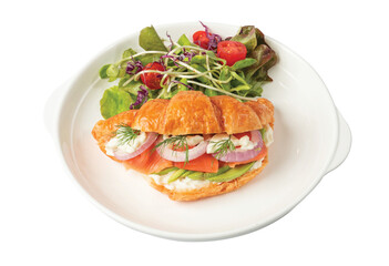 Png Croissant sandwich with salmon on white plate, served with fresh salad leaves. 