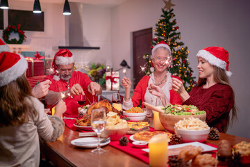 Christmas Celebration. Happy family celebrate Christmas and new year with sparklers celebrating Christmas at home.