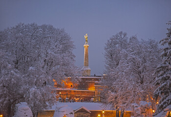View of Kalemegdan Fortress in winter in snow and Victory Monument in background. Winter scene in the evening.