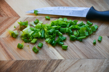 Fresh green onions on a cutting board.