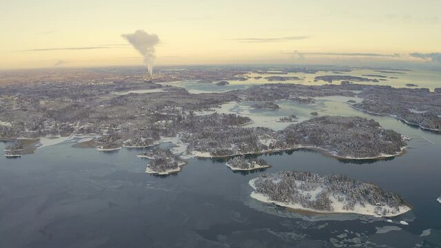 Aerial View Of Winter Finnish Archipelago.Snow-covered islands. The sea is frozen. Scandinavia.