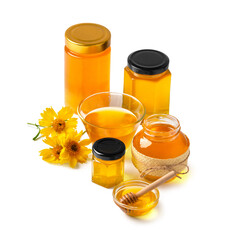Honey in a glass jar and yellow flowers on a white background