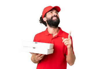 Pizza delivery man with work uniform picking up pizza boxes over isolated chroma key background...