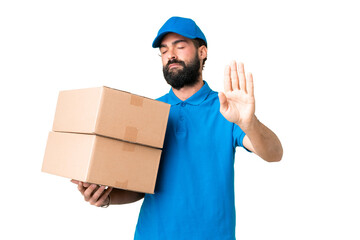 Delivery caucasian man over isolated chroma key background making stop gesture and disappointed