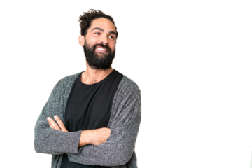 Young man with beard over isolated chroma key background with arms crossed and happy