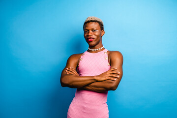 Smiling ethnic transgender person in blue background