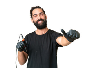 Fototapeta na wymiar Tattoo artist caucasian man over isolated chroma key background giving a thumbs up gesture