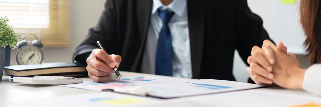 Business partnership concept, Senior in business point on document to explaining data with partner