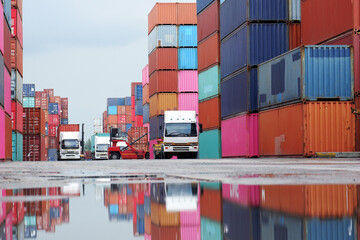 Forklifts handling freight, container boxes in logistic shipping yard with stacks of cargo...