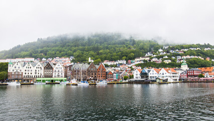Fototapeta na wymiar Bergen, Norway - June 07, 2022: The waterfront a the harbor of Bergen in Norway with the famous Bryggen houses as part of the UNESCO heritage